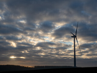 Obraz premium Wind turbine against dramatic sky
