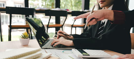Young colleagues discussing business and price chart analyzes business people on the table great in...