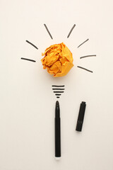 Creative thinking ideas and innovation concept. Paper scrap ball yellow colour with light bulb symbol on white background