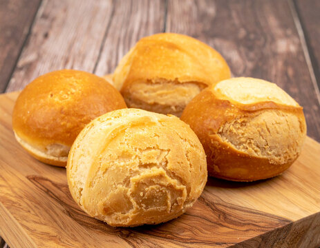 Traditional Salvadoran sweet bread or pastries, like semita or quesadilla salvadore�a, arranged on a wooden surface, showcasing local baking.