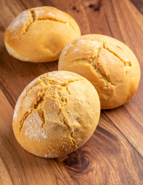 Traditional Salvadoran sweet bread or pastries, like semita or quesadilla salvadore�a, arranged on a wooden surface, showcasing local baking.
