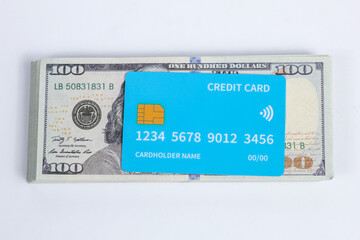 Fototapeta premium credit card on top of a stack of hundred dollar bills