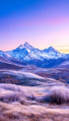 Obraz premium Serene sunrise over snow-capped peaks and frosted foothills