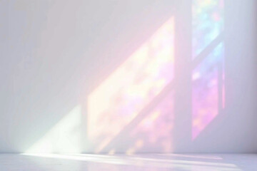 Dreamy holographic rainbow light refraction texture overlay with abstract soft bokeh effect on a white wall. Organic prismatic glow and natural shadows