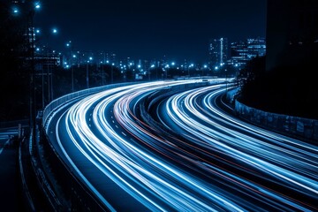 Night highway curves, city lights, light trails