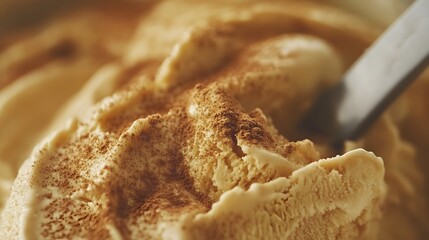50. Close-up view of pumpkin spice ice cream with cinnamon dust on top, capturing the creamy texture