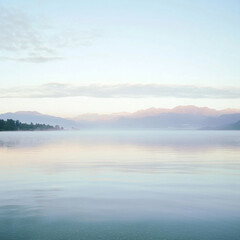 Fototapeta premium A golden sunset reflects over the calm lake, painting the sky with warm hues of orange, pink, and purple. Nature's perfect end to the day—peaceful, mesmerizing, and full of quiet beauty.