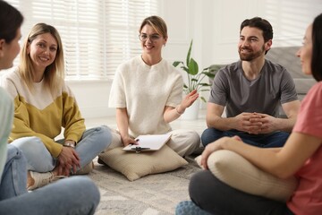 Group of people having psychotherapy session indoors