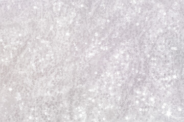 Shiny mother-of-pearl iridescent rainbow silk with glitter.