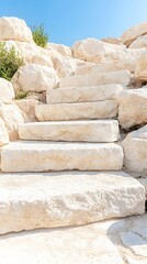 Sun-drenched stone steps ascend a rocky hillside, showcasing a blend of natural and man-made elements under a clear blue sky