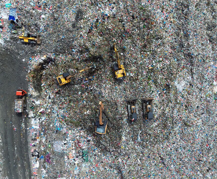 Aerial top view of excavators working on a landfill site in Medan, Indonesia – November 17, 2024