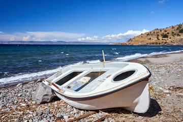 ruined boat on rocky coast on Lesbos island