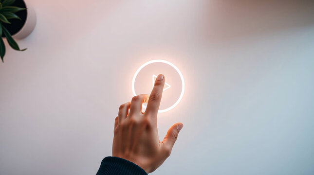 Hand touching glowing play button, interactive digital media interface.