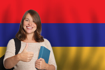 Happy woman student against Armenian flag background. Travel, education and learn language in...