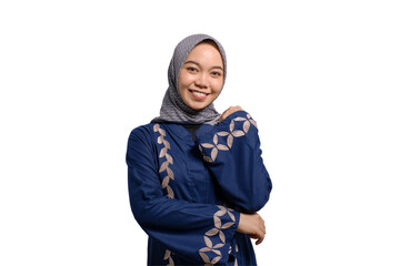 Smiling young Asian Muslim woman looking at camera feeling confident and happy isolated on...