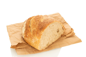 One half of a loaf of bread with a paper bag isolated on a white background, close-up.