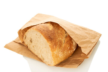 One half of a loaf of bread with a paper bag isolated on a white background, close-up.