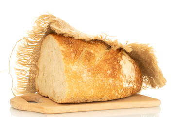 One half of a hearth bread on a bamboo board isolated on a white background, close-up.