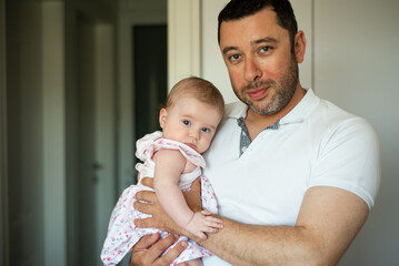 father holding his newborn baby