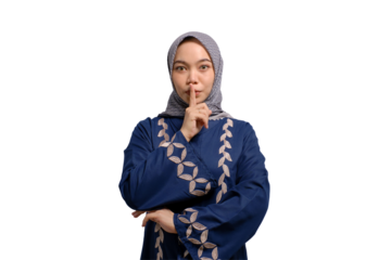 Serious young Asian Muslim woman showing silence gesture isolated on transparent background