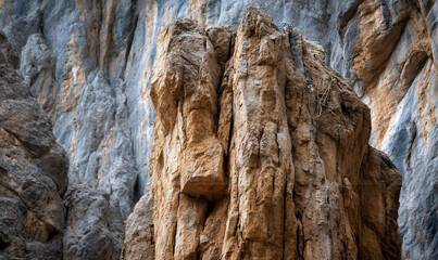 Majestic rock formation, sunlit, textures of stone in natural setting