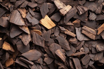 A pile of wood chips with some brown and some black pieces