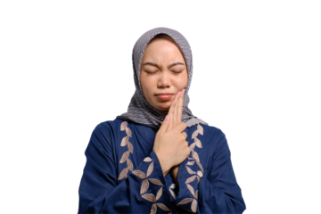 Young Asian Muslim woman feeling pain, holding her cheek with hand, suffering from severe toothache isolated on transparent background