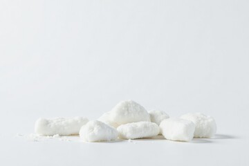 Lumps of white sugar against a white backdrop, still life, macro