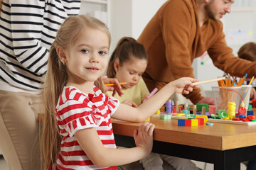 Cute girl at desk during lesson in school