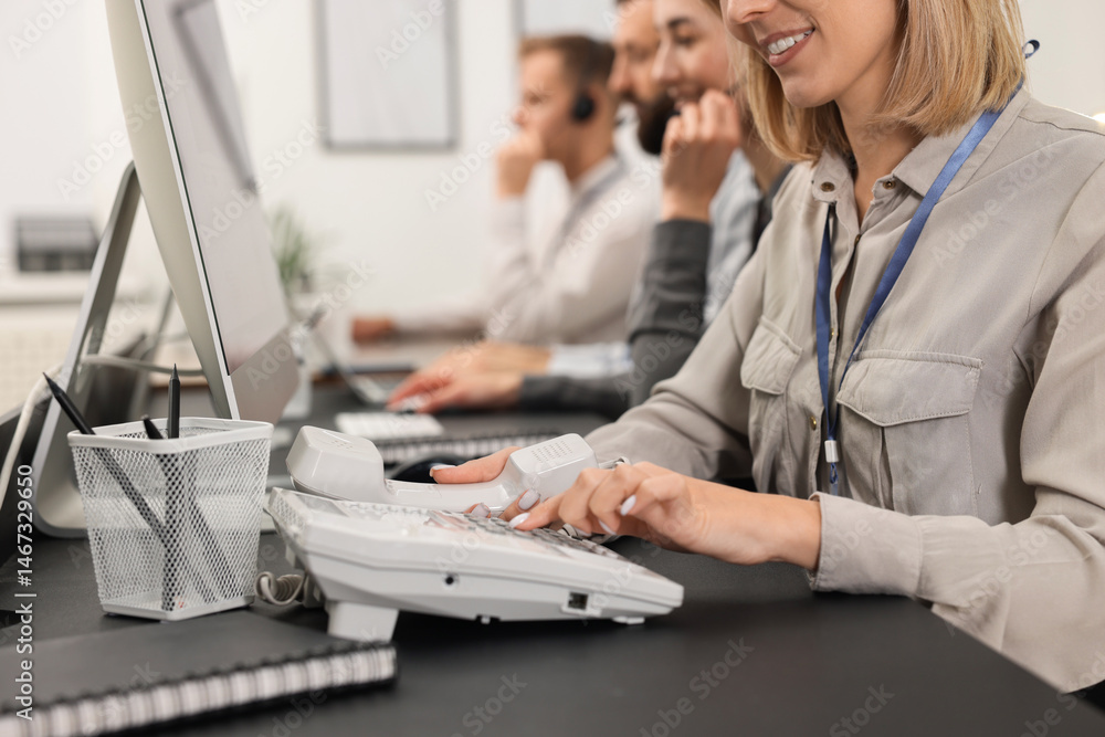 Aufkleber technical support call center. team of operators working at table in office, closeup