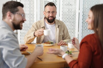 Colleagues chatting during lunch break in office