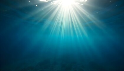 Fototapeta premium Underwater shot with sun rays penetrating the surface, creating a bright glow in the deep blue water, seabed visible at the bottom