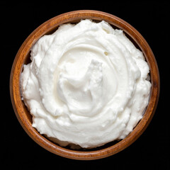 a bowl of coconut cream isolated on black background