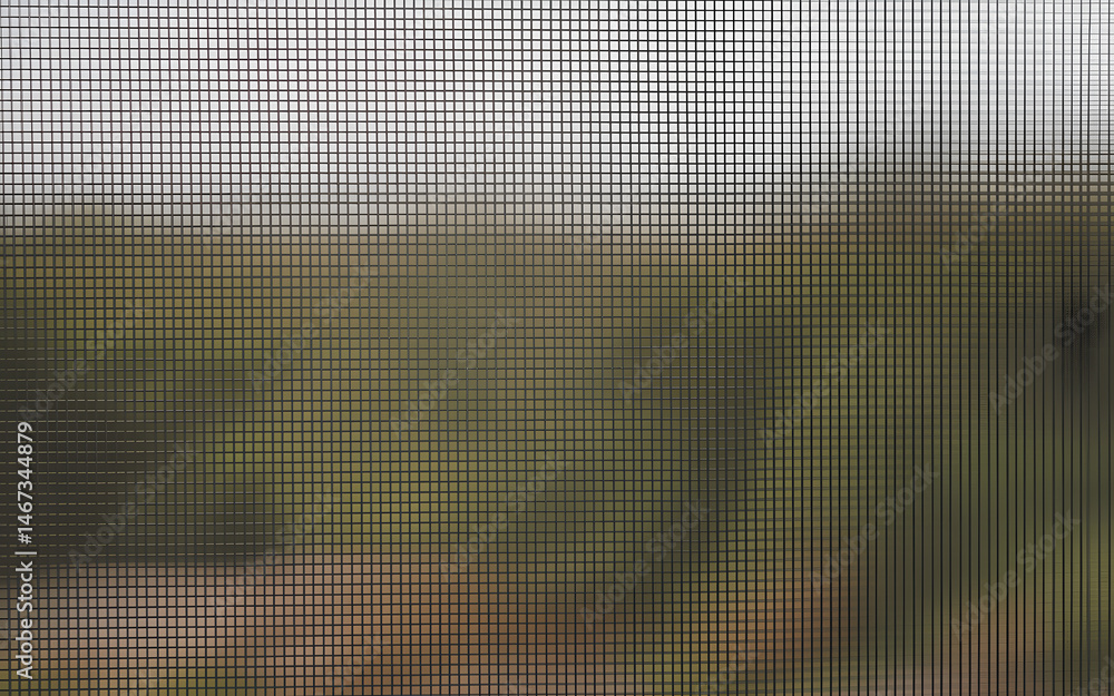 Aufkleber the fine grids of a window screen partially obscuring a natural green background in a blurred focus.