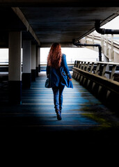 silhouette of a woman walking in the car park