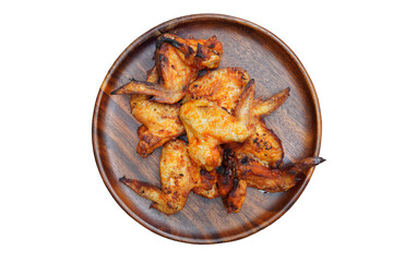 Grilled chicken wings on old round wooden plate, transparent background.