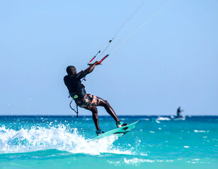 Man Kiteboarding In Turquoise Ocean