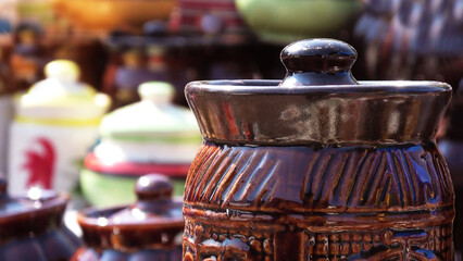Colorful ceramic crockery items displayed in a street shop