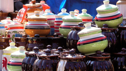 Colorful ceramic crockery items displayed in a street shop