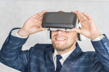 Happy Business man wearing virtual reality glasses.on a light background.