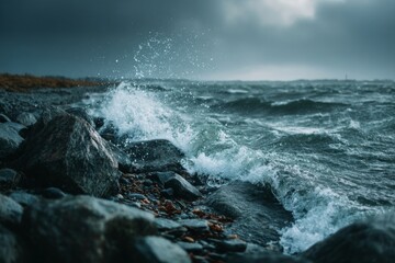 Fototapeta premium Coastal storm with waves crashing on rocky beach under a cloudy, dramatic sky at a moody ocean landscape