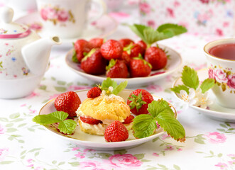 Cream puffs cakes or profiterole filled with whipped cream and strawberries