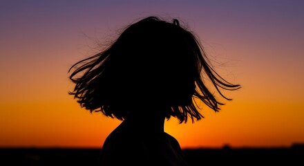 Silhouette of a Person with Short Hair at Sunset