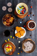 Various sweet food on black chalkboard background. Flat lay. Top view. Food concept.