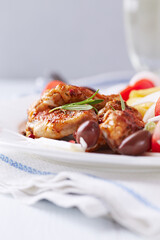 Spicy chicken wings with french fries and tomatoes. Close up.	