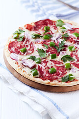 Pizza with salami and mozzarella cheese. Wooden background. Soft focus. Close up.	