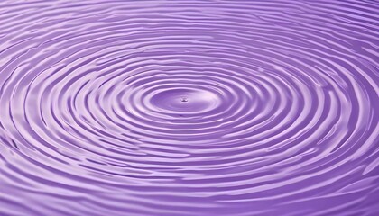 A droplet's impact forms a mesmerizing pattern of concentric ripples in vibrant purple water.