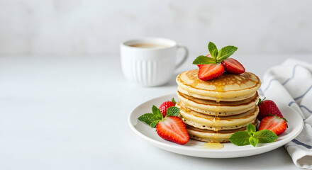 Stack of Pancakes with Strawberries and Mint on White Plate