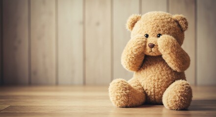 AI image of a cute, fluffy teddy bear sitting on a wooden floor, covering its eyes with its paws, evoking shyness or fear.