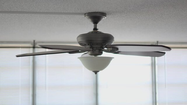 Celling fan middle speed spining heavy wooden fins side look
